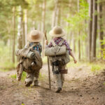 Boys on a forest road with backpacks