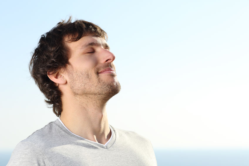 man practicing stillness by taking deep breaths.