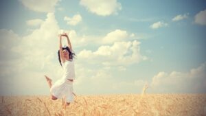 woman jumping for joy, representing living a happy life