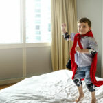 Boy playing superhero.