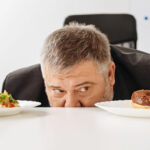 man using willpower to decide what to eat.