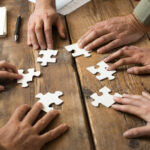 Business men and women work together to solve a problem