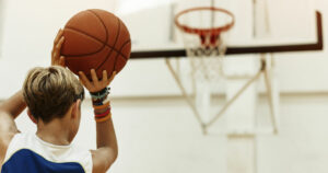 boy shooting basketball