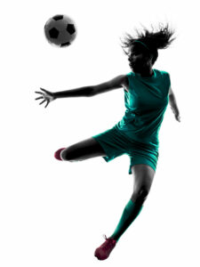 teenage girl playing soccer