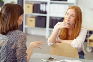 business woman listening to another