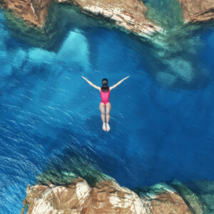 young woman diving into ocean