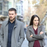 Couple experiencing conflict in marriage walking on a city street