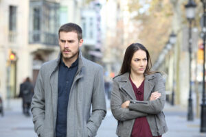 Couple experiencing conflict in their marriage walking on a city street