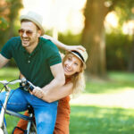 couple having fun riding bicycle together