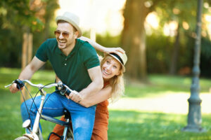 Couple having fun riding bicycle together