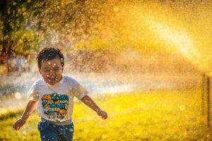 happiness of a little by running through sprinklers
